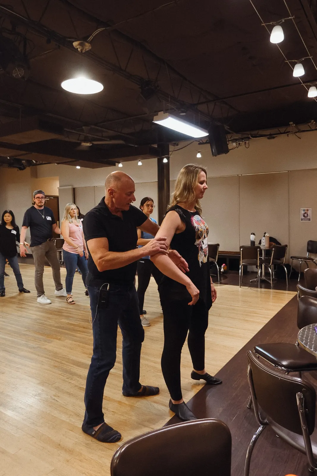 West Coast Swing instructor guiding a student during class at Studio 22 Dallas